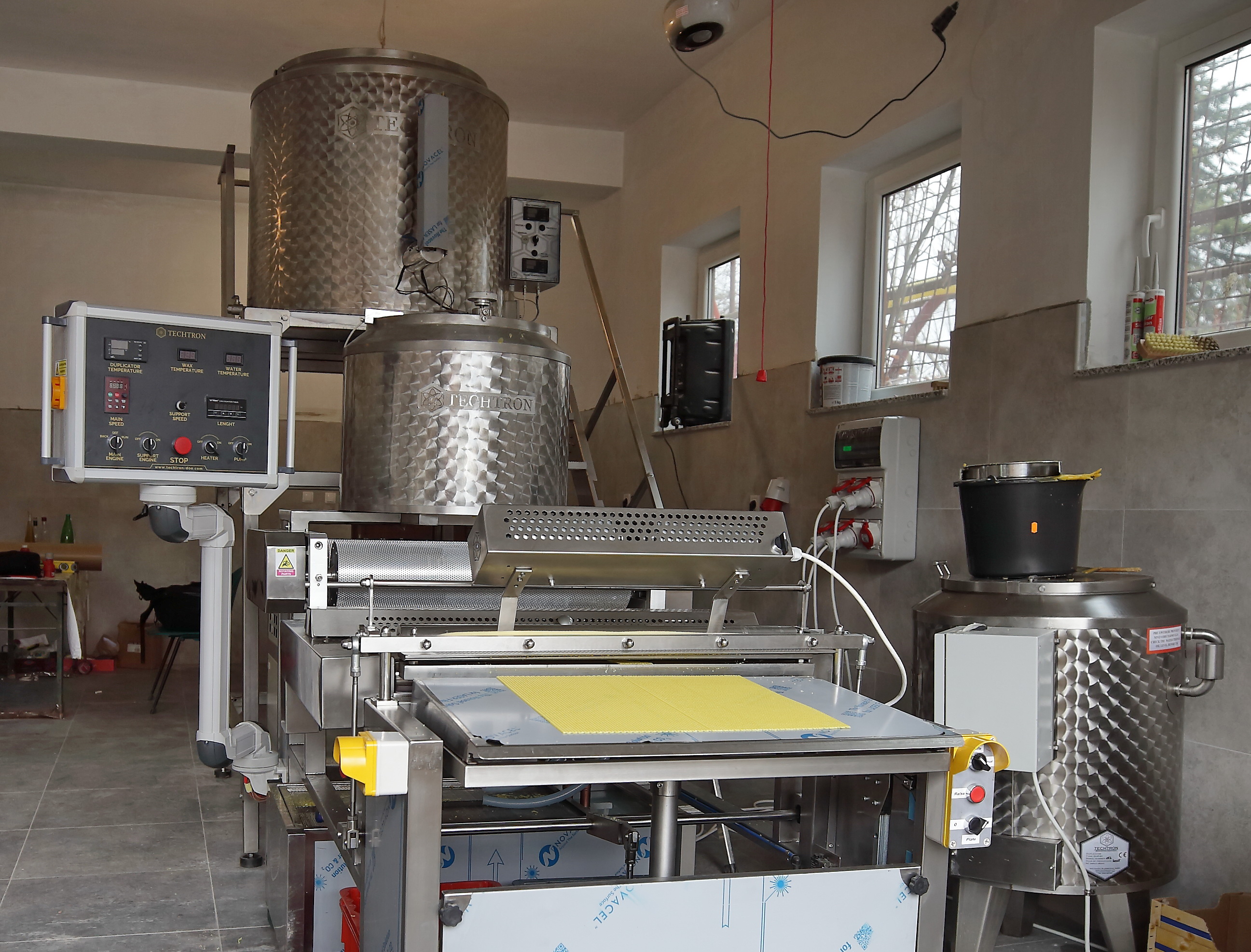 Modern beekeeping equipment and machinery in workshop setting